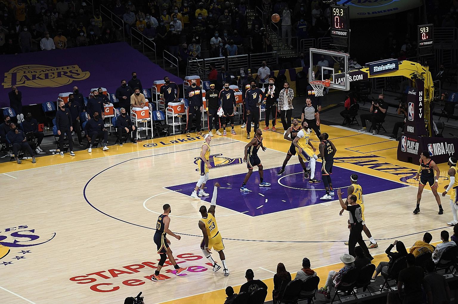 LeBron James showing the mark of greatness with a 34-foot basket as the shot clock winds down to lead the Los Angeles Lakers past the Golden State Warriors at the Staples Centre on Wednesday. The 103-100 win set up a first-round play-off against the 