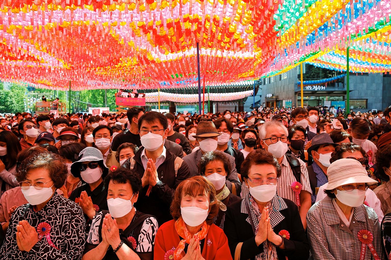 South Koreans at a ceremony on Wednesday marking the anniversary of the birth of Buddha at Jogye temple in Seoul. The country's vaccination campaign has been hampered by global shortages and shipment delays. PHOTO: REUTERS