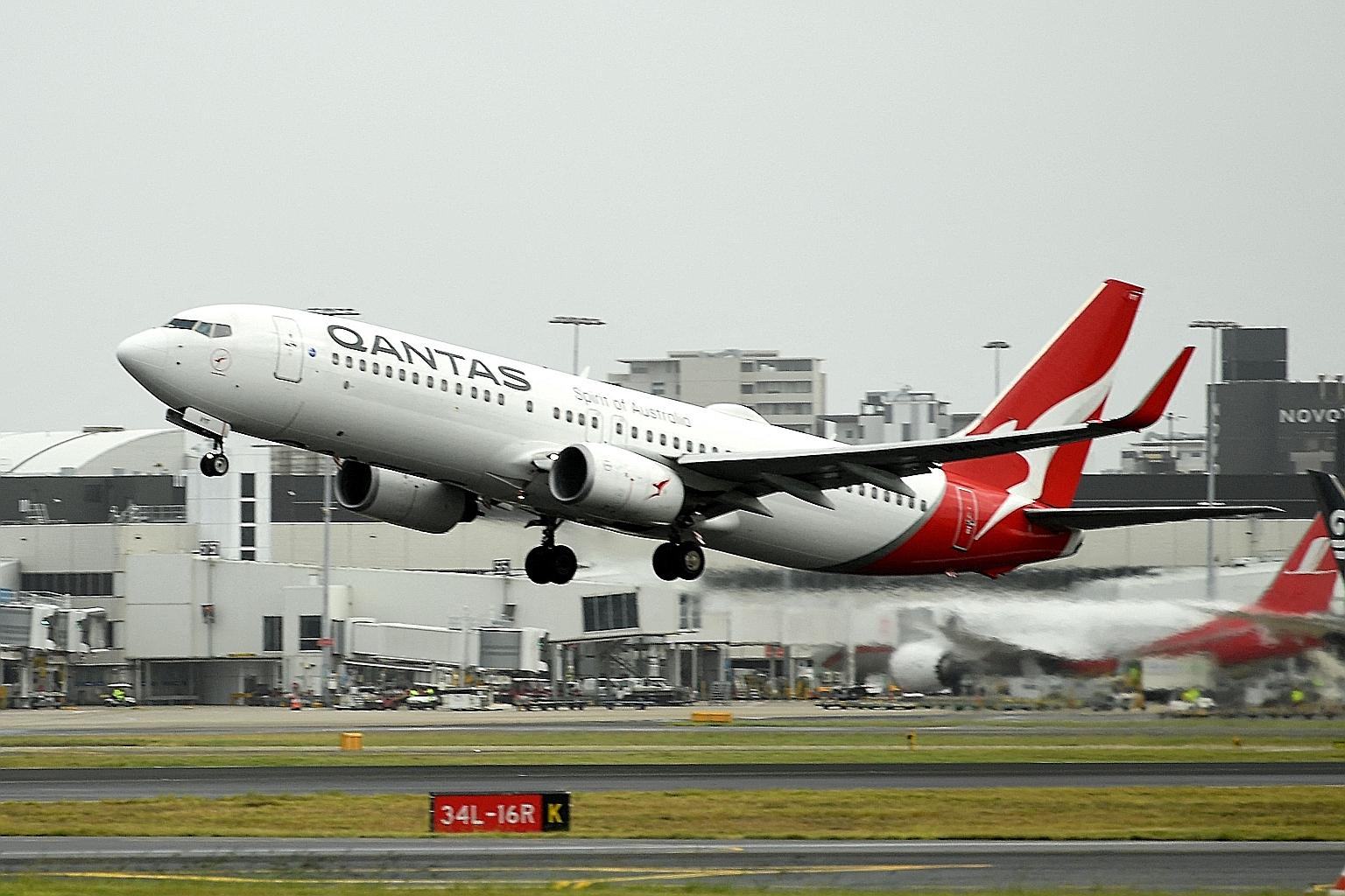 Qantas Airways' new initiatives include a two-year wage freeze, slashing commission to travel agents on international tickets, and offering voluntary redundancy to cabin crew in its international division. PHOTO: AGENCE FRANCE-PRESSE