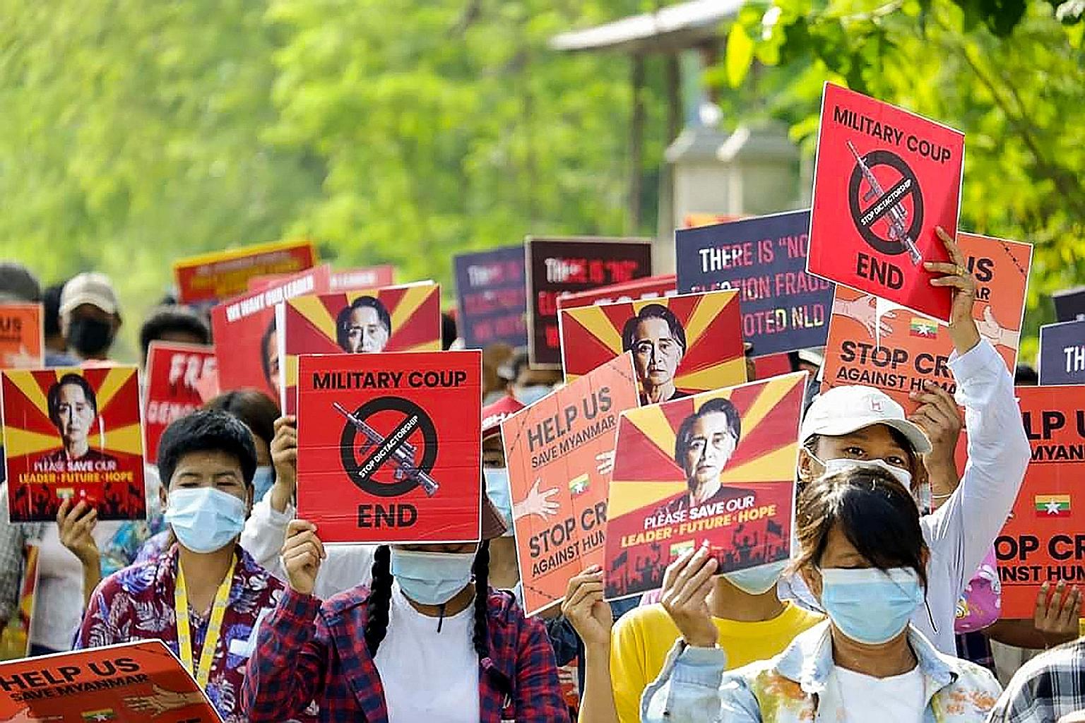 Demonstrators in Myanmar's north-western town of Kale with posters featuring detained civilian leader Aung San Suu Kyi during a protest against the military coup this week.