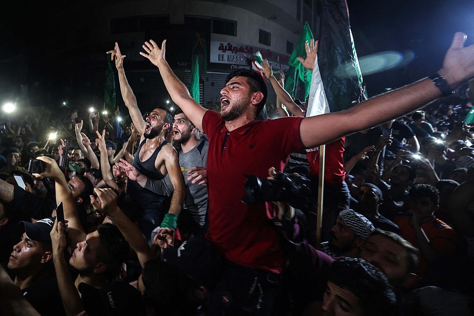 Palestinians celebrating in the streets following a ceasefire brokered by Egypt between Israel and Hamas in the Gaza Strip yesterday. The violence erupted on May 10, triggered by Palestinians' anger at what they saw as Israeli curbs on their rights i