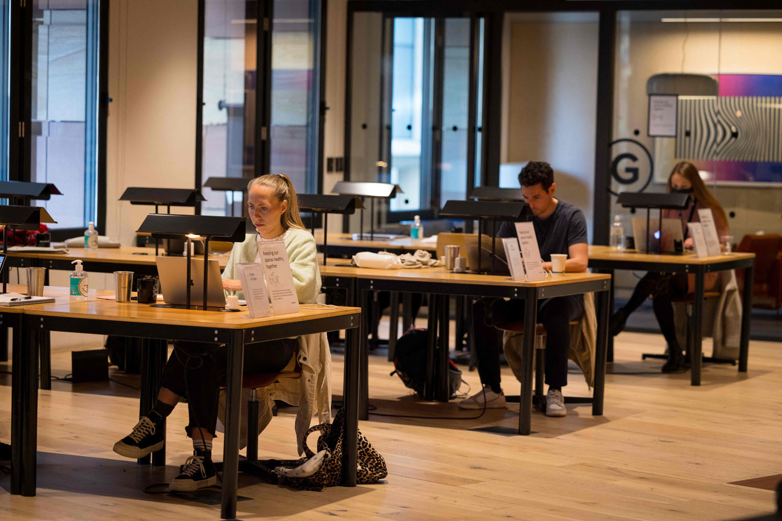 People working at a WeWork outlet in London last month. The office-sharing start-up said that its business was recovering as more people returned to offices due to the easing of Covid-19 curbs. Total occupancy hit 50 per cent in the first quarter, up