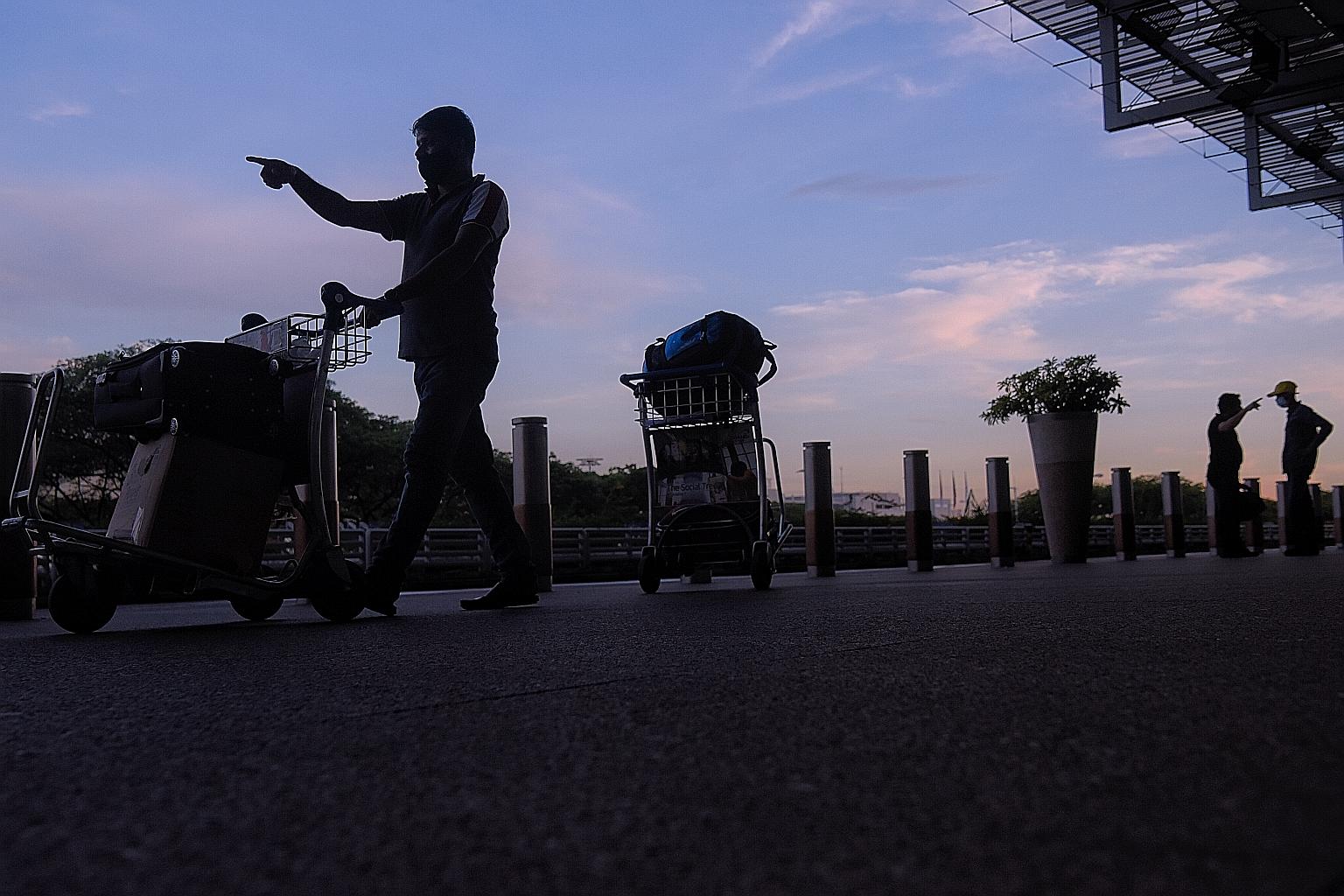 A passenger walking into the departure hall at Changi Airport Terminal 3 on May 14. The Terminal 3 cluster has ballooned in the past week to more than 100 people.