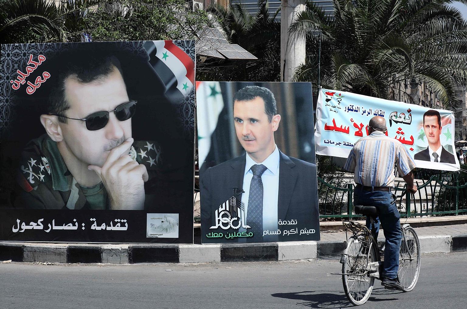 Election billboards of Syrian President Bashar al-Assad, for tomorrow's ballot, in Damascus on Sunday. The election is all but certain to deliver a fourth term for a leader already in power for 21 years.
