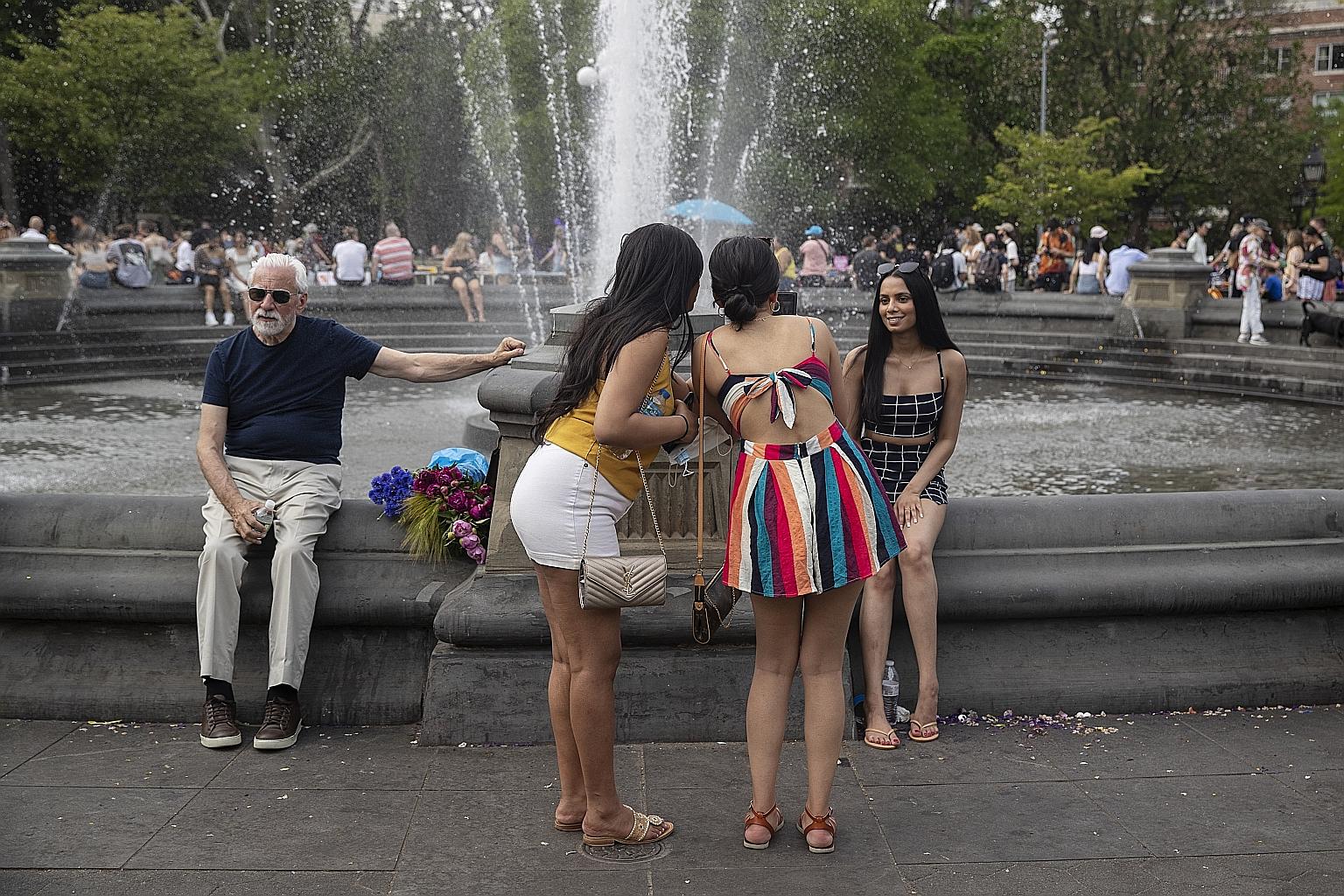 People at a fountain in Washington Square Park in New York last Saturday. The US is reporting about 25,700 coronavirus cases daily, a 39 per cent decrease from two weeks ago. Deaths are down 14 per cent over the same period to an average of 578 per d