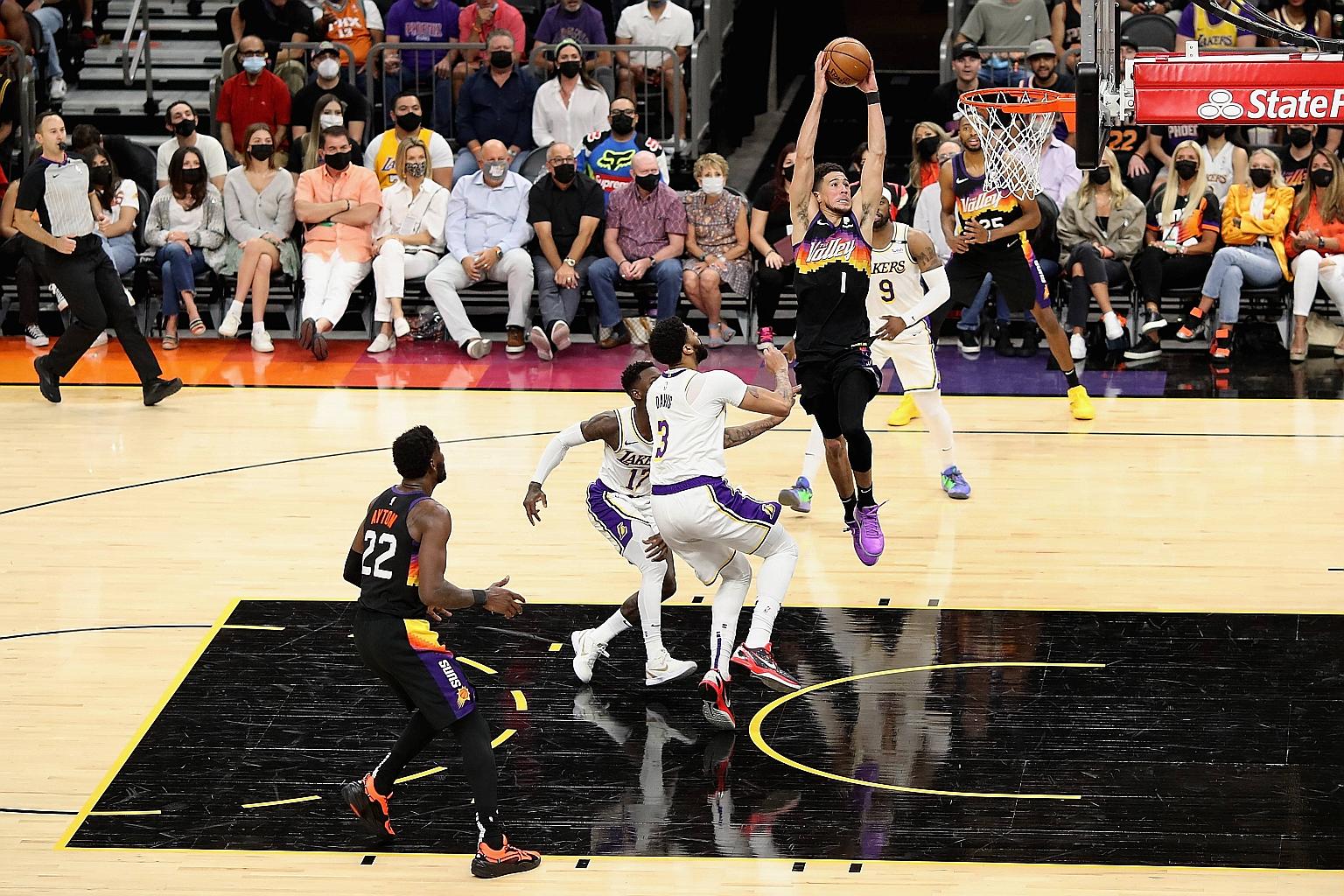 Suns guard Devin Booker dunking the ball over Lakers star Anthony Davis. The 24-year-old had a game-high 34 points while fellow NBA play-off debutants Deandre Ayton and Mikal Bridges finished with 21 and 10 points respectively on Sunday.