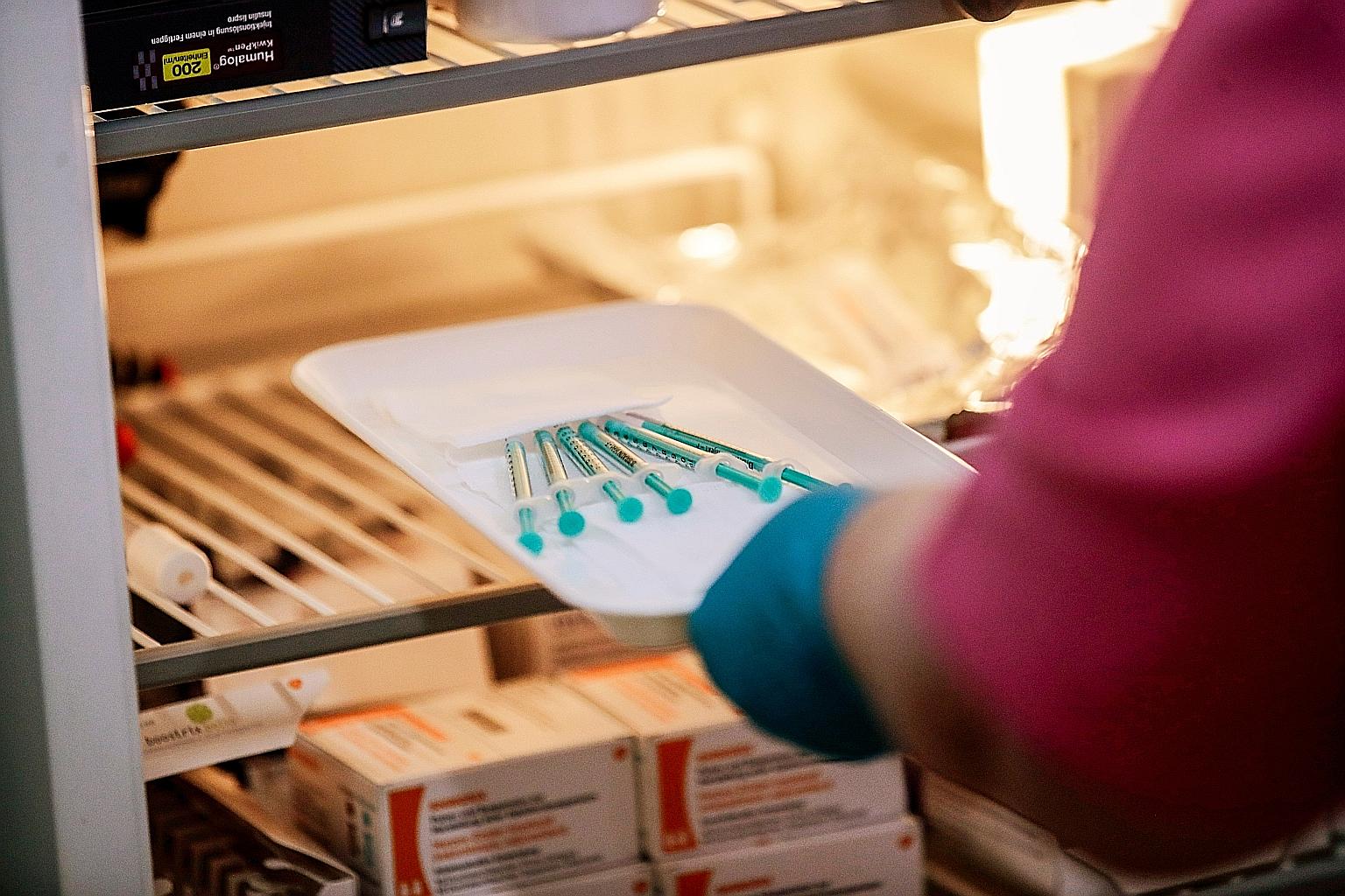 Syringes with doses of the Pfizer-BioNTech vaccine, which was originally approved for use with a strict set of storage conditions. PHOTO: REUTERS