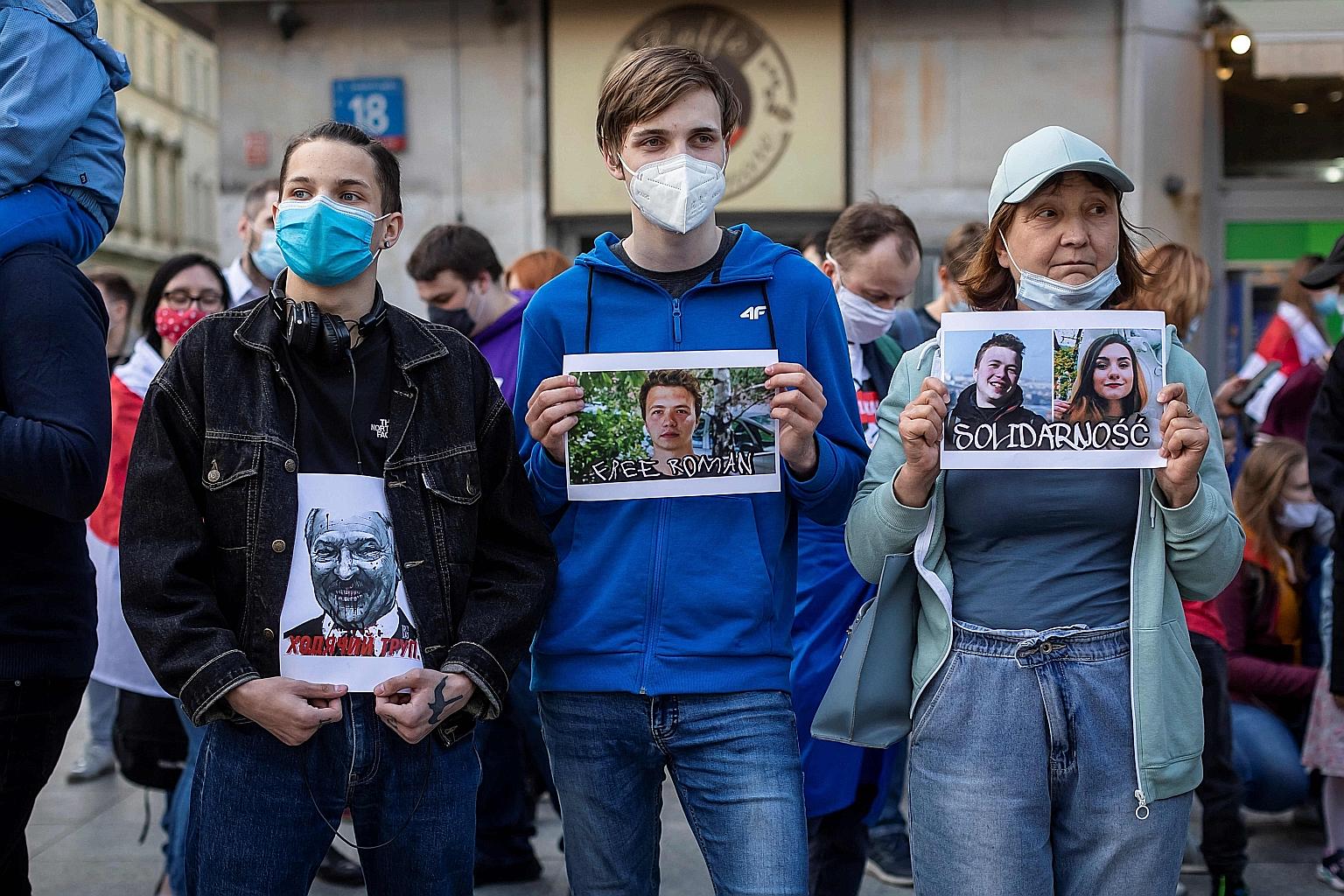 Belarusian protesters in Poland holding images of (from left) Belarus strongman Alexander Lukashenko, opposition activist Roman Protasevich and a combined photo of the arrested dissident with his Russian girlfriend Sofia Sapega during a demonstration