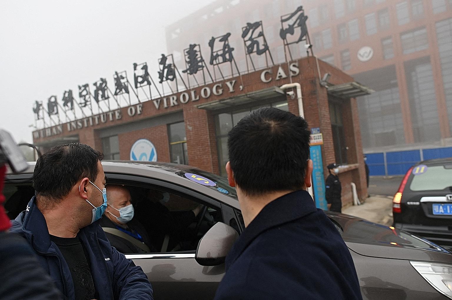 The WHO investigation team arriving by car at the Wuhan Institute of Virology in February. Although a joint report by the WHO and China scientists in March dismissed a laboratory accident as "extremely unlikely", it was criticised - including by the 
