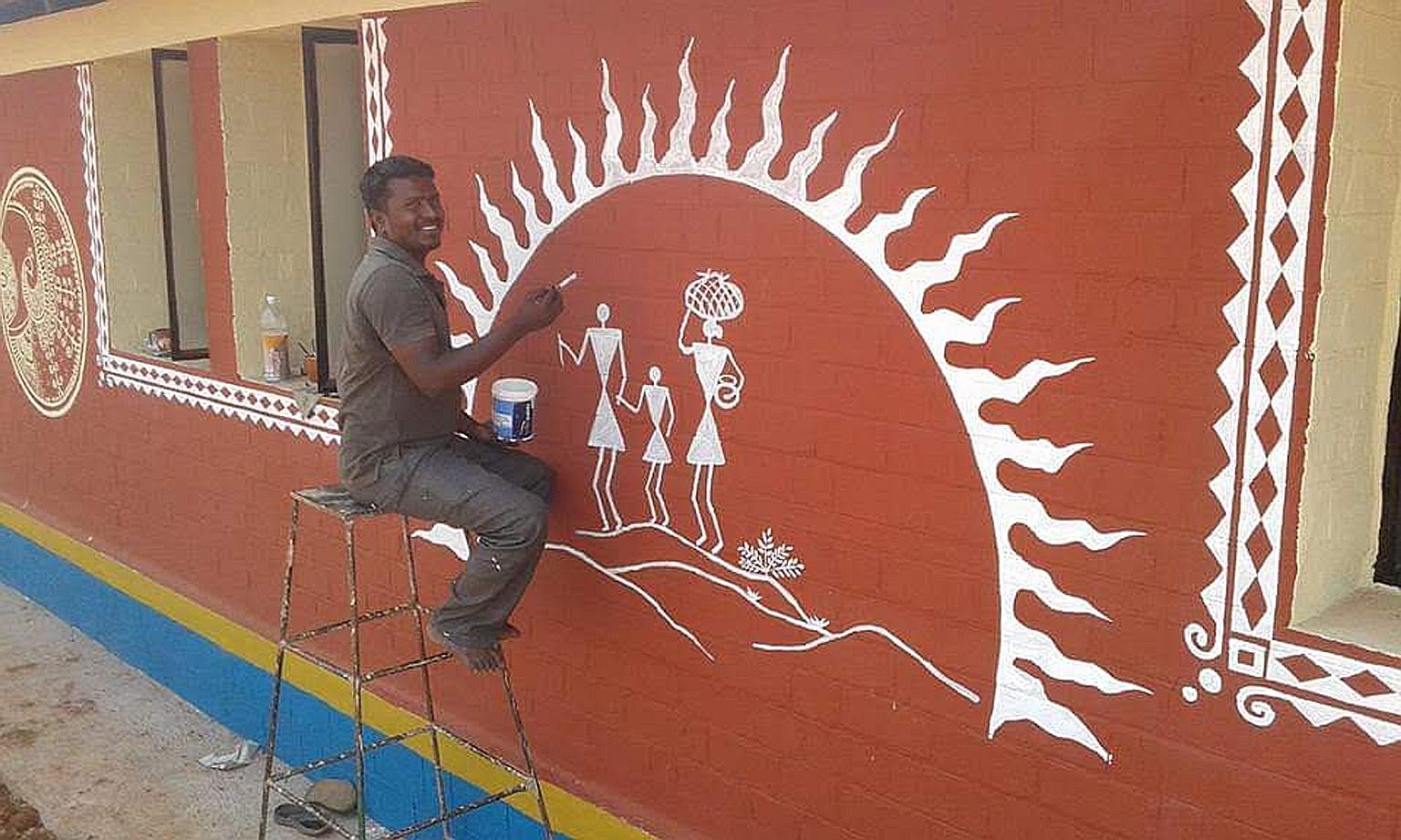 Mr Nanjundasamy M. working on a community mural for a sustainable farming collective called Amrita Bhoomi - the Evergreen Earth.