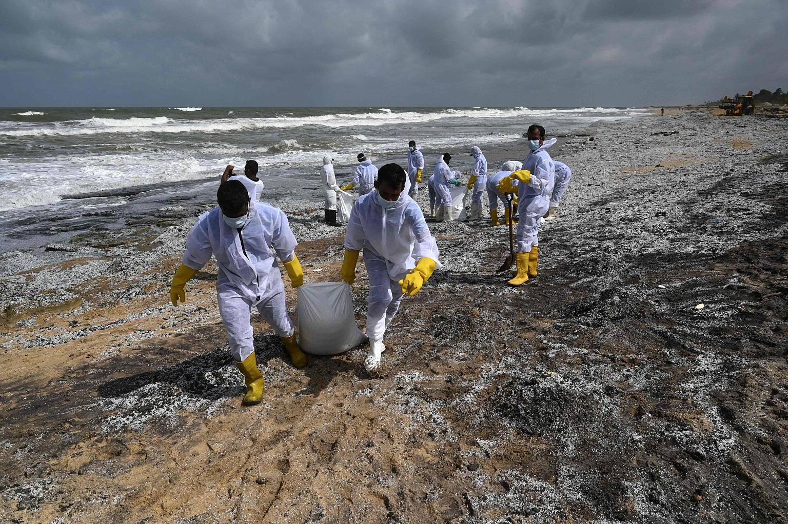 Sri Lankan navy soldiers removing debris washed ashore from the container ship X-Press Pearl at a Colombo beach yesterday. The vessel was on its way to Singapore from India when a fire broke out on May 21. PHOTO: AGENCE FRANCE-PRESSE