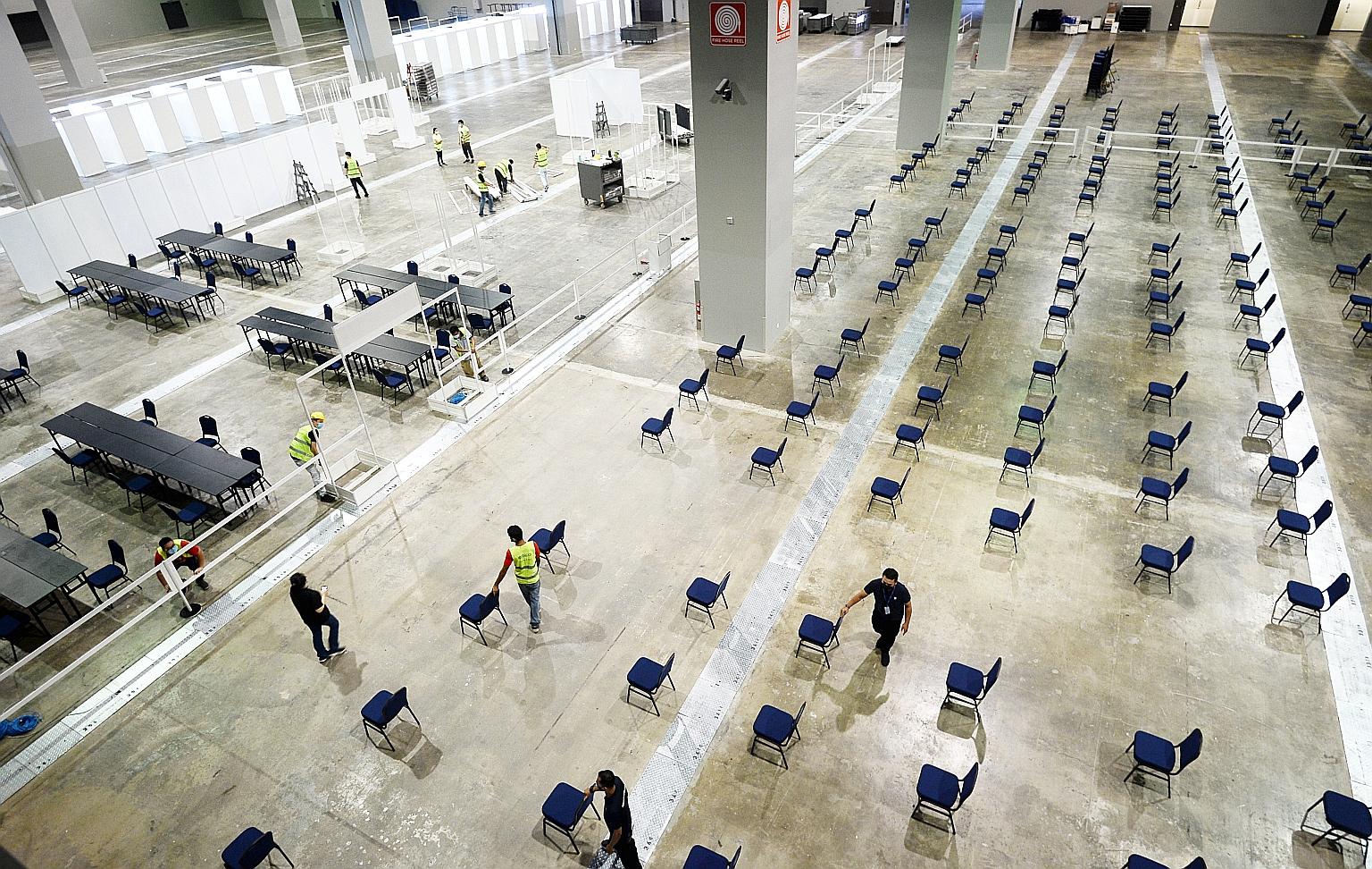 Staff preparing a hall in the Malaysia International Trade and Exhibition Centre on Thursday for the mega vaccination centre, which is expected to see over 5,000 people inoculated against Covid-19 daily.