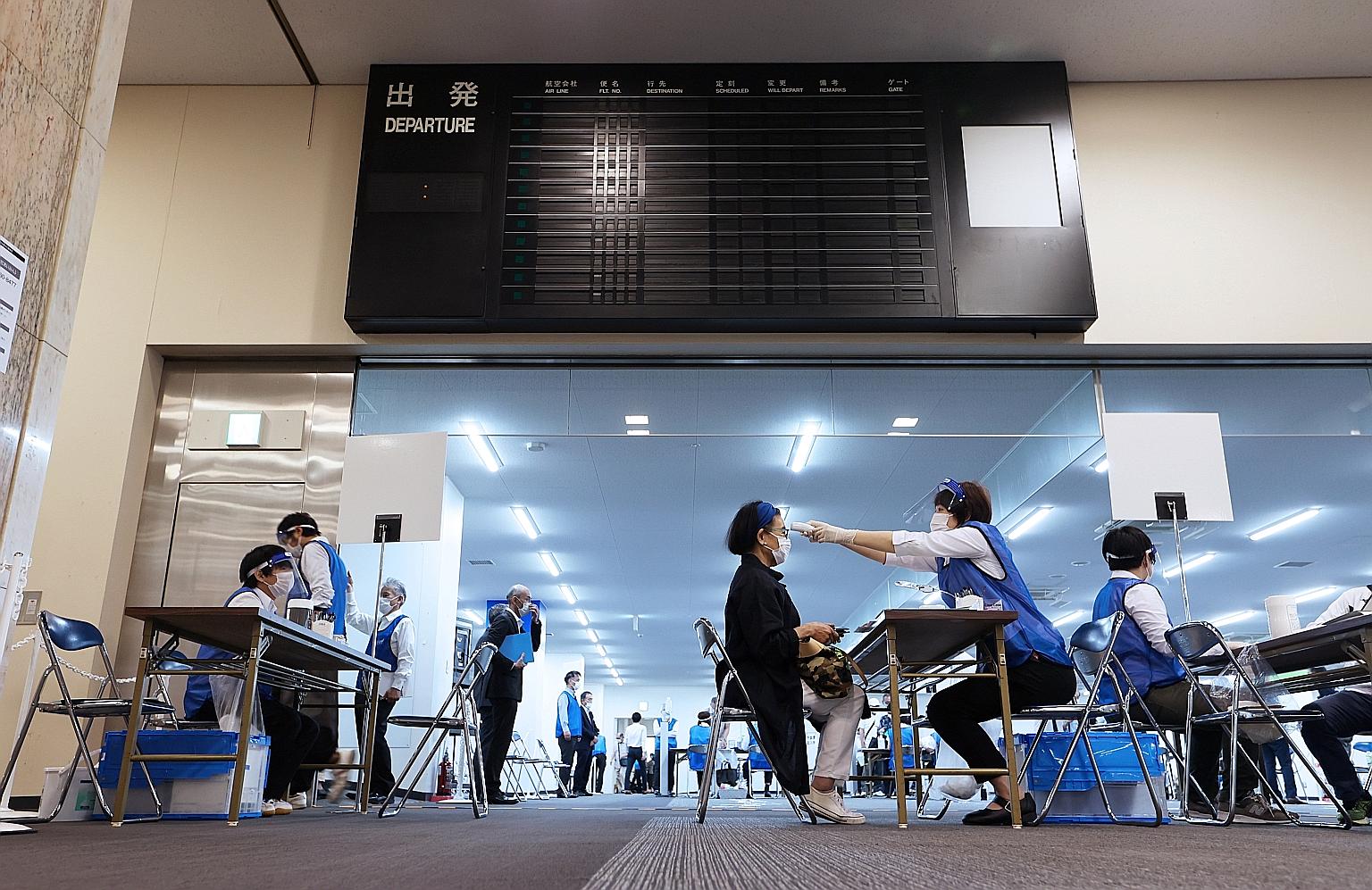 A Covid-19 vaccination centre in Japan's Nagoya airport. Mass inoculation centres have opened in the country this week, and the government has enlisted dentists and military medics in its effort to deliver one million shots a day by the middle of nex