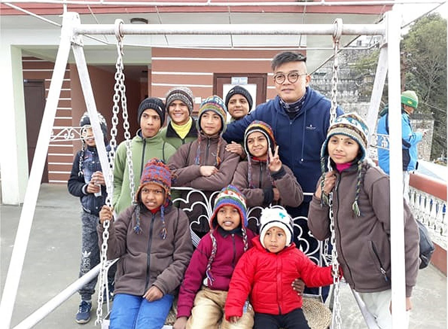 Station Inspector Jeff Lim Kok Hwee with children from a village in Kathmandu, Nepal, in 2019. He is one of the founding members of a volunteer group in the Singapore Police Force that aims to help the underprivileged in Singapore and overseas. PHOTO