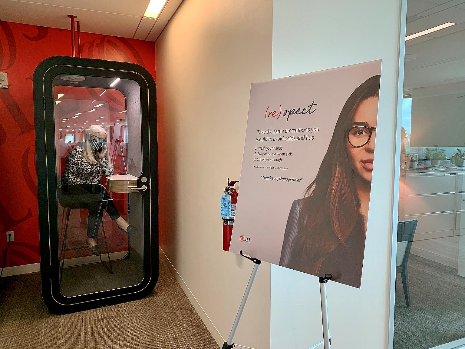 An employee making a call in a newly installed phone booth at real estate company JLL's office in Austin, Texas. As United States bank employees prepare to return to offices in the coming months because of the pandemic easing, their employers are bri
