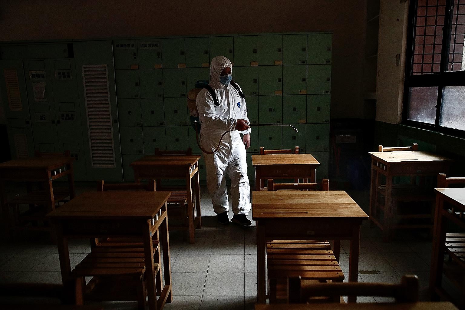 A worker disinfecting a classroom in Taipei earlier this month. Teachers at public, private and cram schools, where children go after school to catch up on schoolwork, are scrambling to keep classes going for their students, with the summer break sti