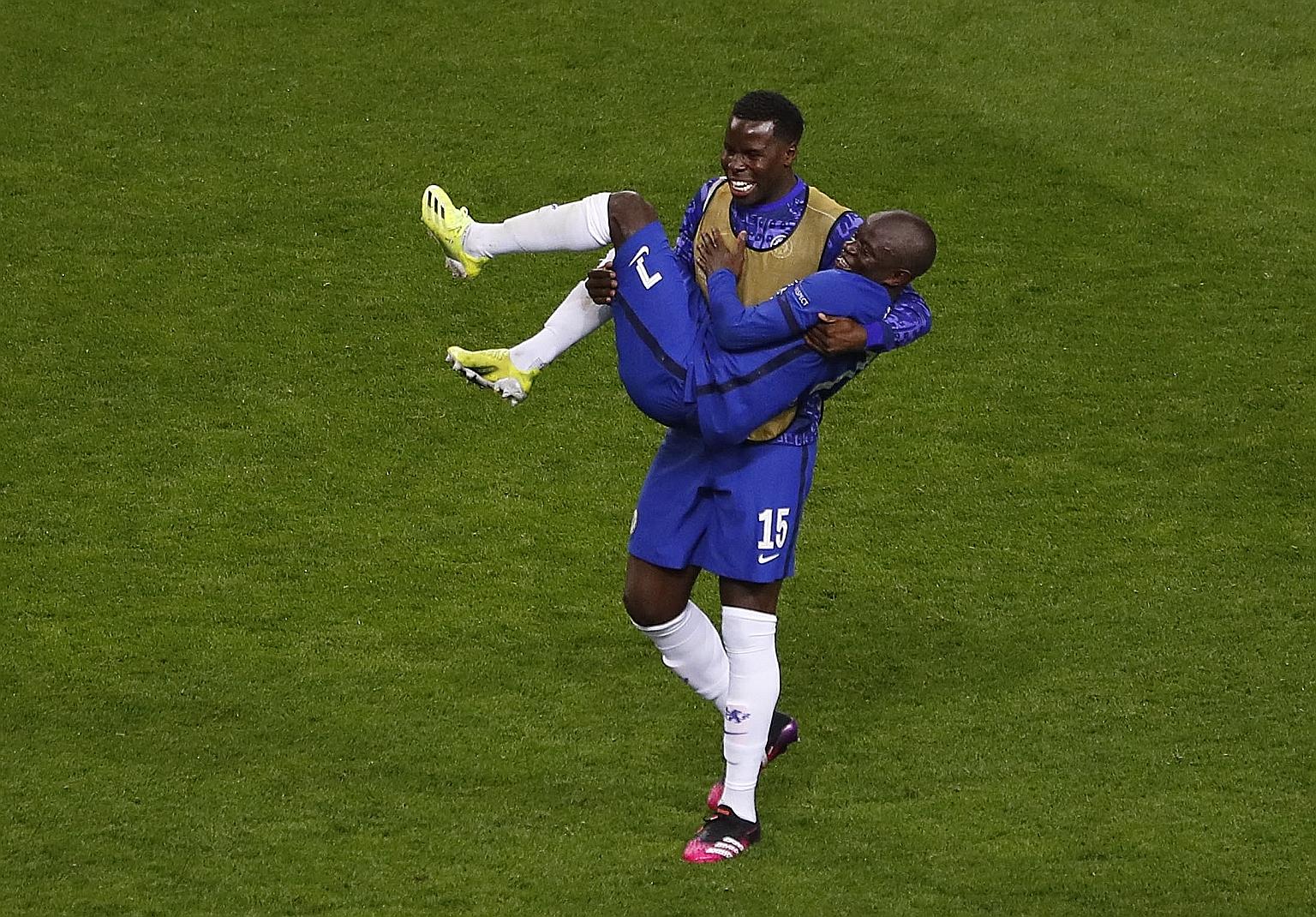 Blues defender Kurt Zouma carrying N'Golo Kante after the France midfielder recovered the ball 10 times and won 11 duels without committing a foul in his man-of-the-match showing against City. PHOTO: REUTERS