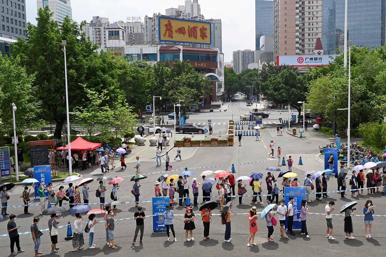 People queueing to receive the Covid-19 vaccine outside a jab site in Guangzhou on Saturday. The total number of confirmed infections in China to date stands at 91,061, with 4,636 deaths.
