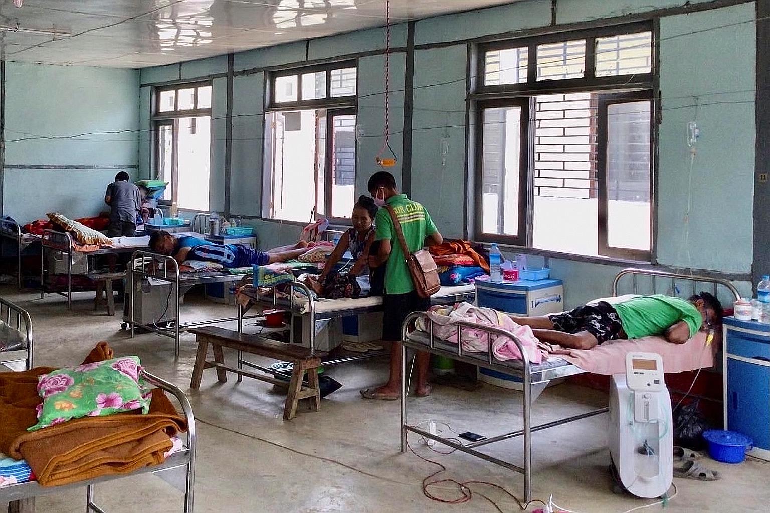 Covid-19 patients at a hospital in Cikha, Myanmar, on Friday. Patients with Covid-19 symptoms started showing up at the hospital in the middle of this month. As it is only 6km from India, health workers fear the illness could be due to the highly inf