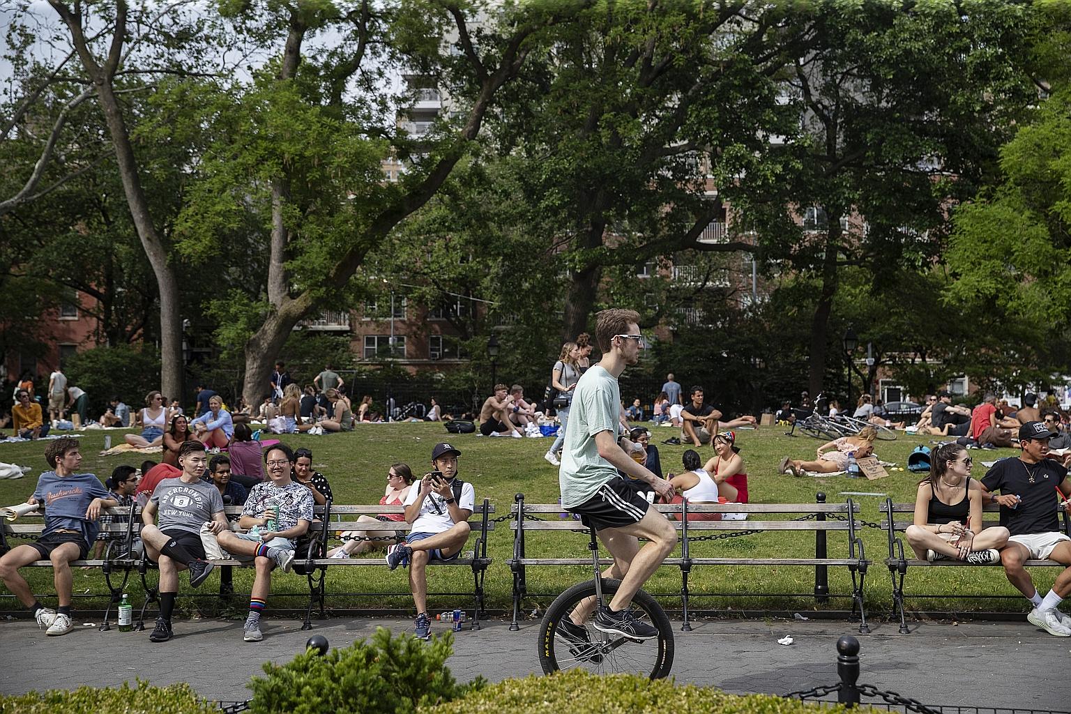 People in Washington Square Park in New York on Saturday. Though 40.5 per cent of the American population have been fully vaccinated, many analysts and epidemiologists remain cautious.