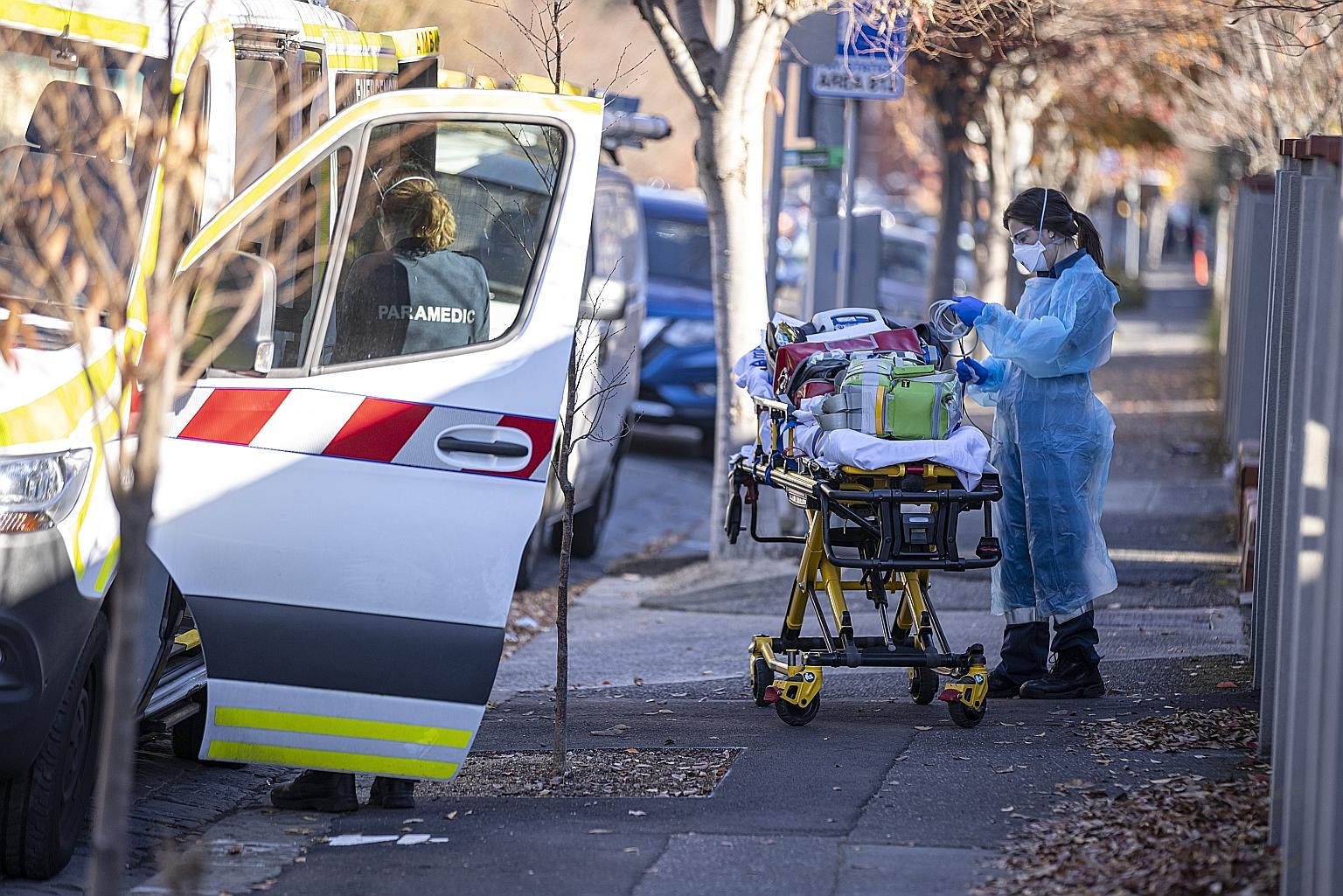 Paramedics returning their equipment to an ambulance in Melbourne yesterday. The authorities have identified several Melbourne schools, supermarkets, department stores and gyms among hundreds of exposure sites. PHOTO: EPA-EFE