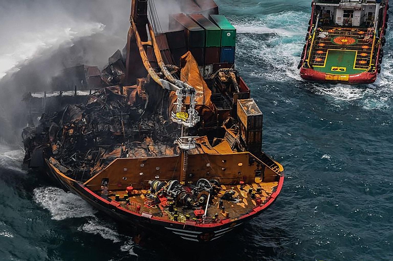Smoke billowing from the Singapore-registered container ship X-Press Pearl in the sea off Sri Lanka's Colombo Harbour on Sunday, in a photo released by the Sri Lanka Air Force. Police said detectives have interviewed the vessel's skipper and chief en