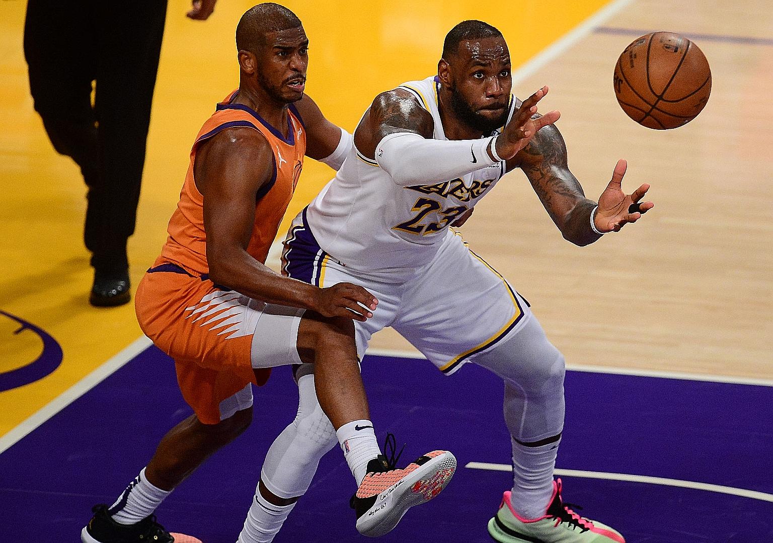 Los Angeles Lakers forward LeBron James trying to beat Phoenix Suns guard Chris Paul to the ball on Sunday. The Suns won 100-92 and tied the series at 2-2.