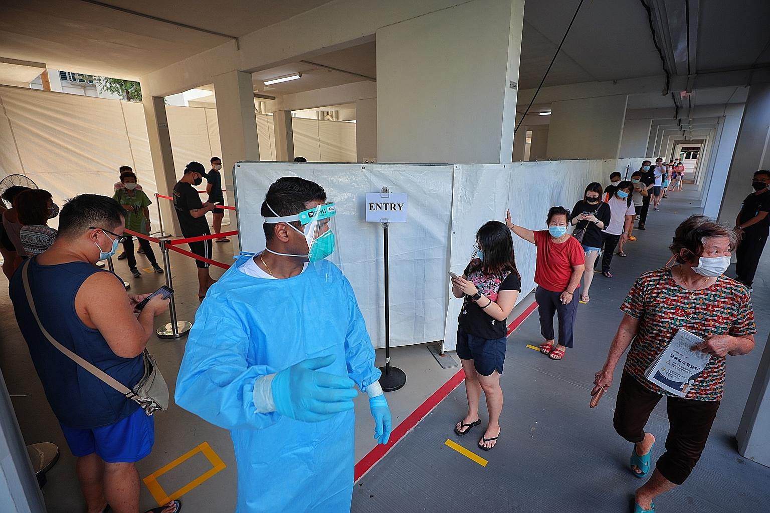 Residents of Blocks 501 and 507 in Hougang Avenue 8 queueing up for Covid-19 testing yesterday at the void deck of Block 507. The residents were informed about the mandatory testing on Monday, after Covid-19 viral fragments were detected in wastewate