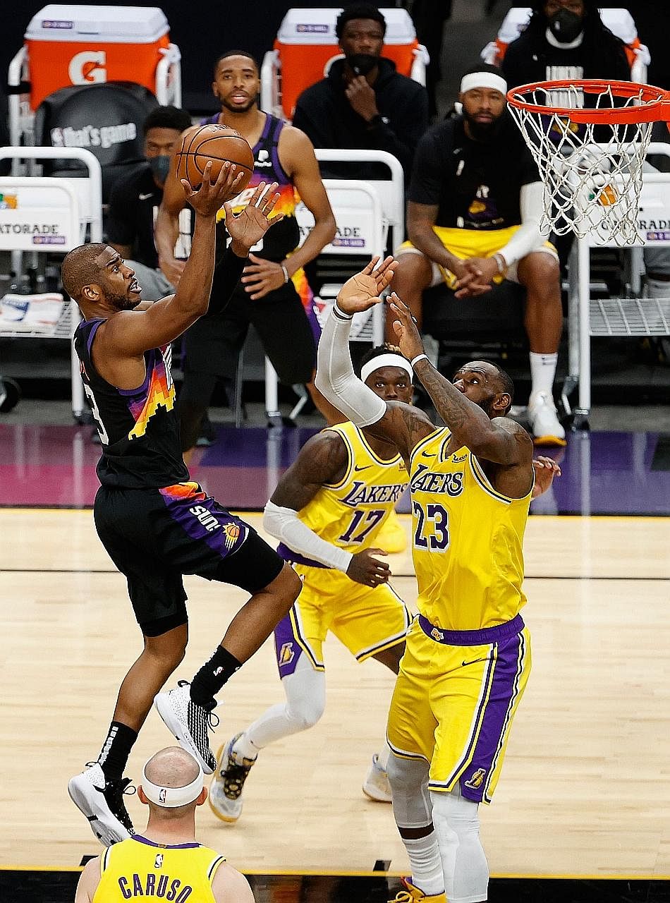Chris Paul driving to the basket while LeBron James tries to defend. The Suns won 115-85, with Game 6 to be played in Los Angeles.