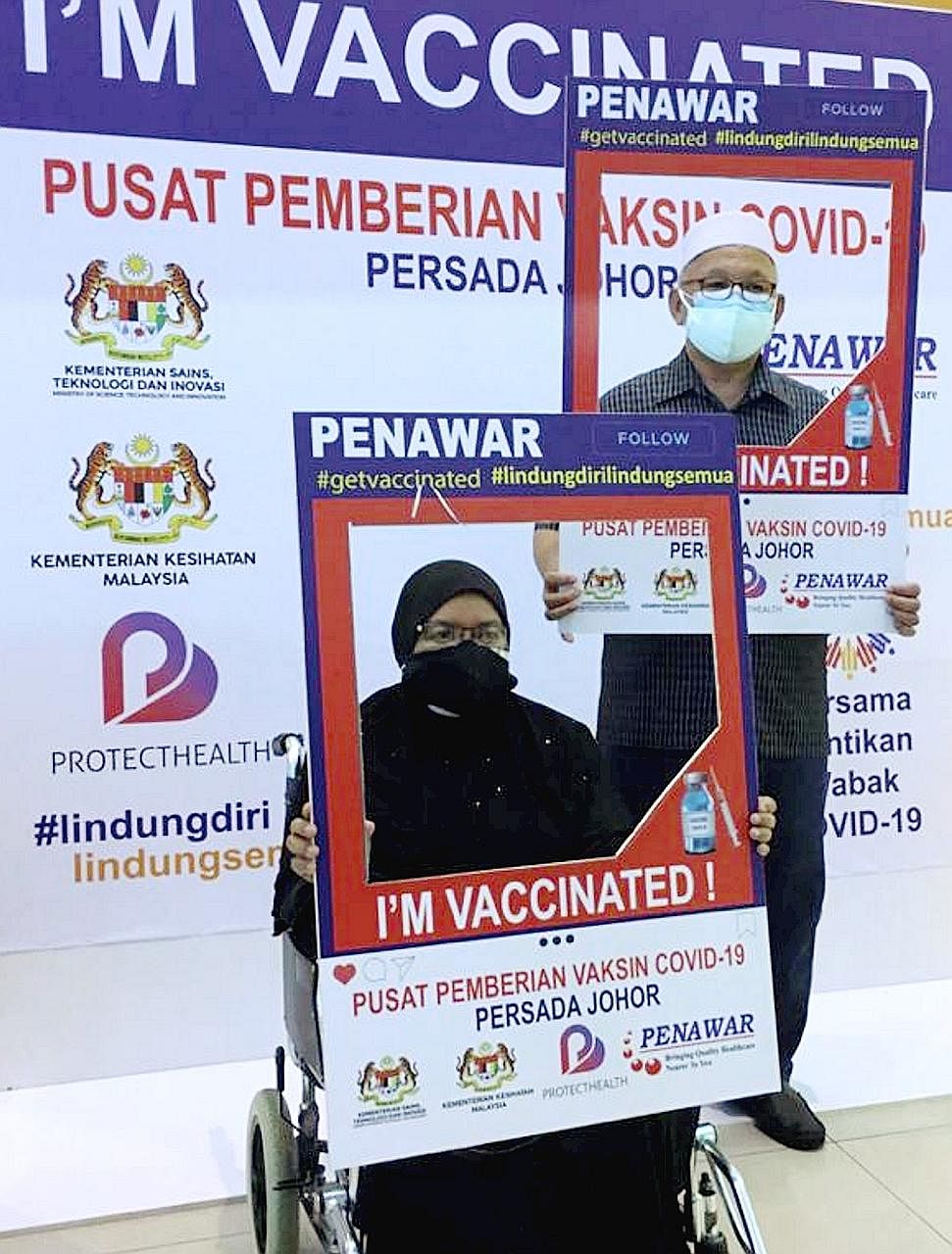 Retired school principal Idris Ahmad, 67, and his wife Azmah Hairun, 64, drove 127km from their home in Batu Pahat district in Johor to Johor Baru to get vaccinated against Covid-19 on Monday. The couple, seen here posing for a photo after getting th