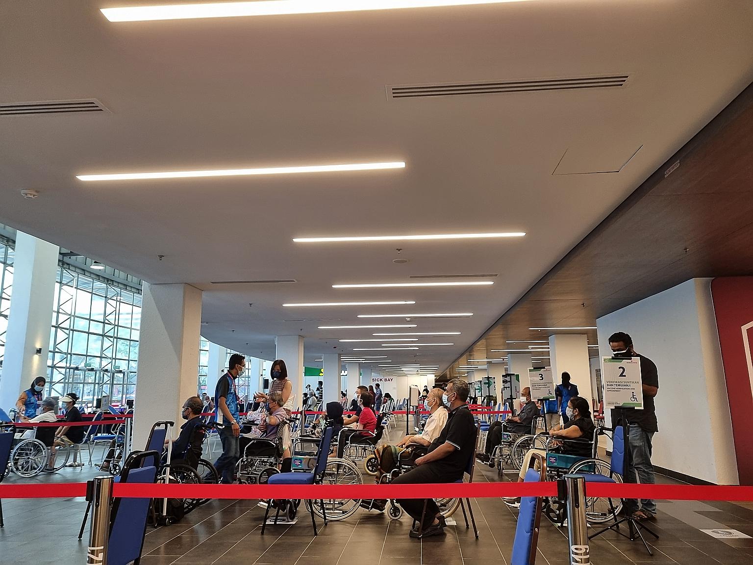People at the Axiata Arena mega vaccination centre in Kuala Lumpur. The mega centre approach has raised concerns of overcrowding, and high-risk and vulnerable groups having to make long journeys to these centres.