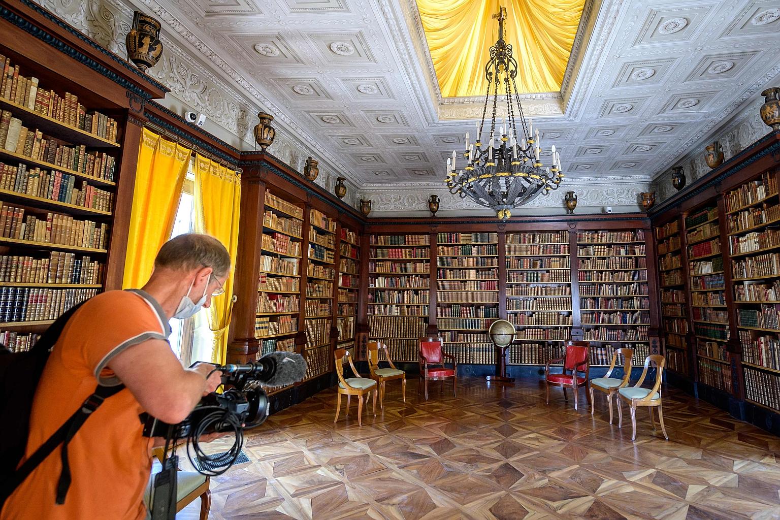 A television cameraman in a room in the Villa La Grange, where US President Joe Biden and Russian President Vladimir Putin are scheduled to have a meeting on Wednesday in Geneva, Switzerland. It will be their first face-to-face meeting since Mr Biden