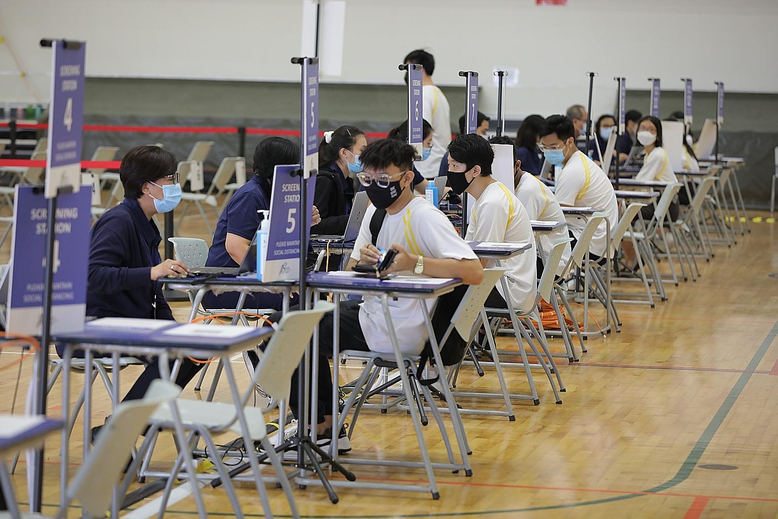 ITE College West students at the vaccination centre's screening area. The fourth MOE vaccination centre at Raffles City Convention Centre opens today. The hope is that all students will be able to get fully vaccinated by the end of August, said Secon
