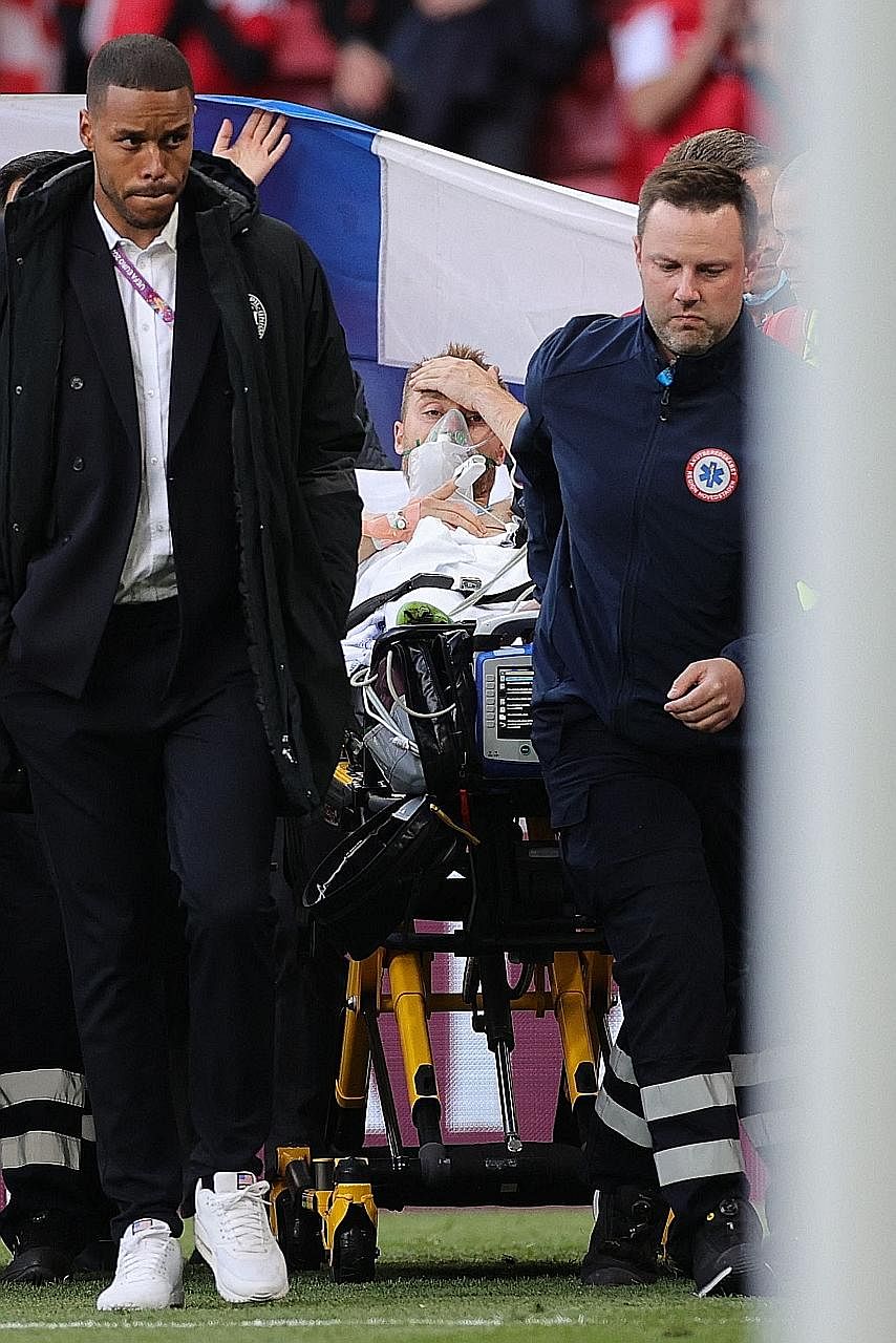 Denmark midfielder Christian Eriksen being evacuated after collapsing on the pitch during his side's Group B clash with Finland on Saturday.