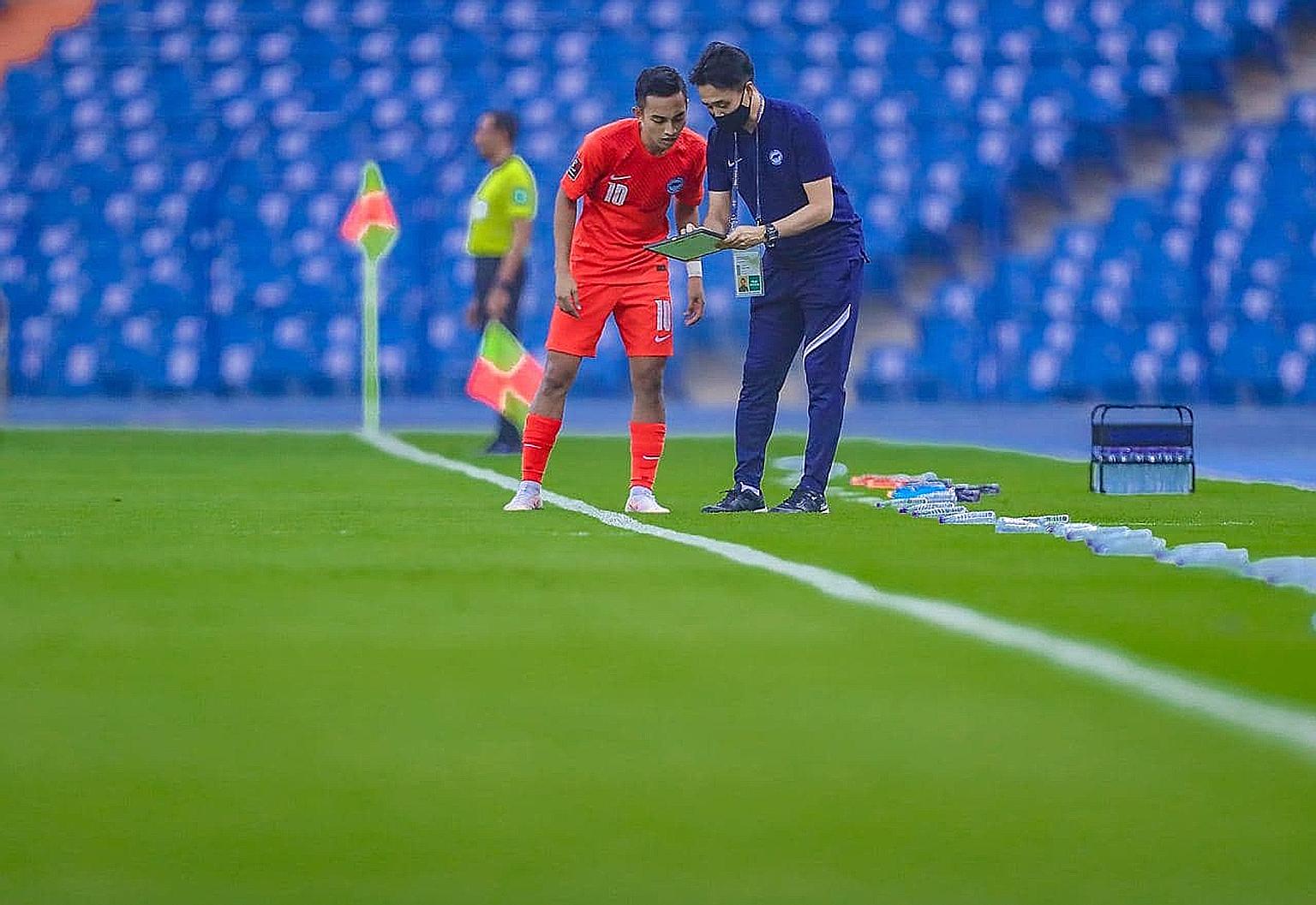 Singapore national team coach Tatsuma Yoshida delivers instructions to forward Faris Ramli during the Lions' final World Cup qualifier against Saudi Arabia last Friday. The Japanese has defended his team selection after consecutive losses to Palestin