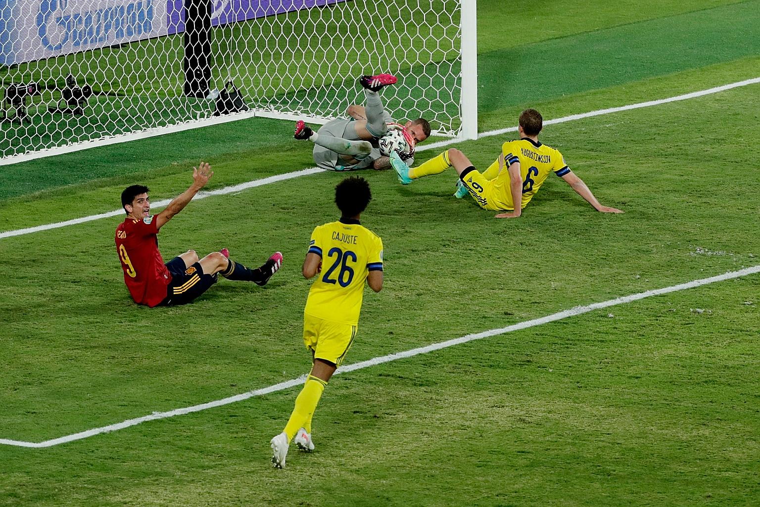 Sweden goalkeeper Robin Olsen making a save in their 0-0 draw against Spain. He faced 17 shots, five of which were on target. Sweden's defensive approach in the game was criticised by Spain coach Luis Enrique, who called the result "very unfair".