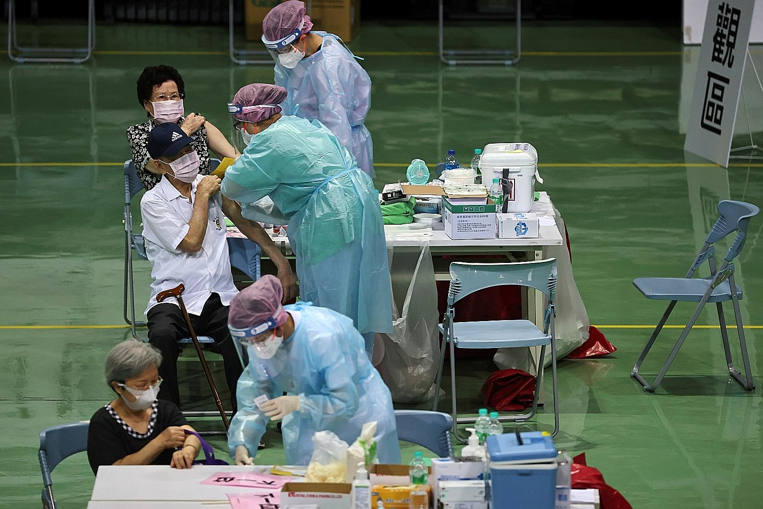 People receiving jabs during a vaccination session for those over 85 years old at a sports stadium in New Taipei City, Taiwan, yesterday. PHOTO: REUTERS
