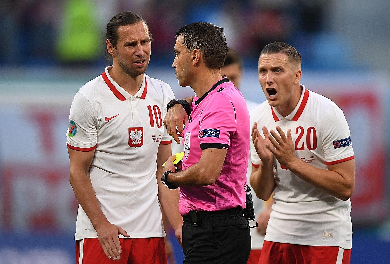 Poland midfielder Grzegorz Krychowiak is sent off by referee Ovidiu Hategan after picking up a second yellow card.