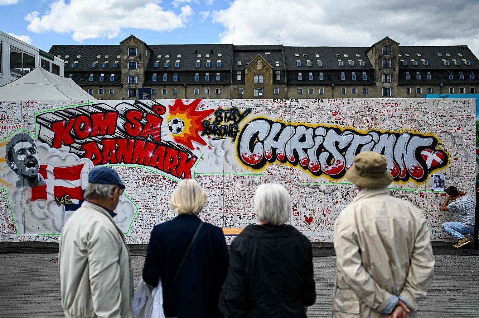 Above: People looking at a mural of midfielder Christian Eriksen at the Football Village at Ofelia Beach in Copenhagen on Tuesday, three days after the Danish star collapsed during the Euro 2020 match against Finland. Left: A smiling Eriksen giving t