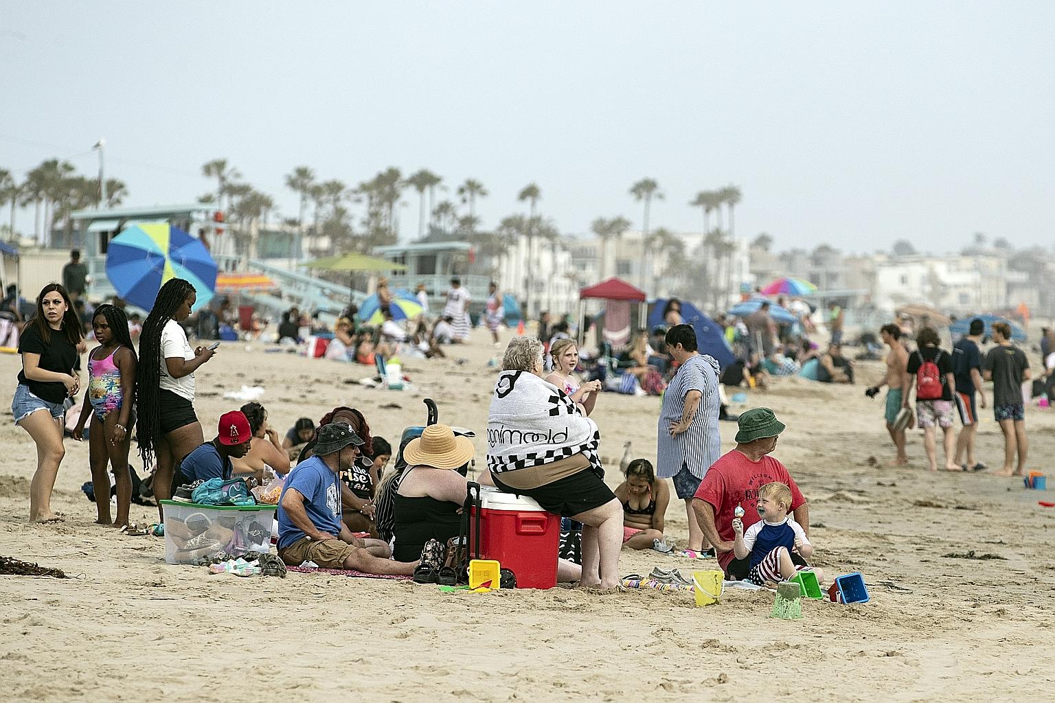 People celebrating the end of Covid-19 curbs at Venice Beach, California, on Tuesday. However, the US was poised to record 600,000 dead from the virus, even as Americans begin to enjoy a summer with fewer limitations, if any, on their ability to live