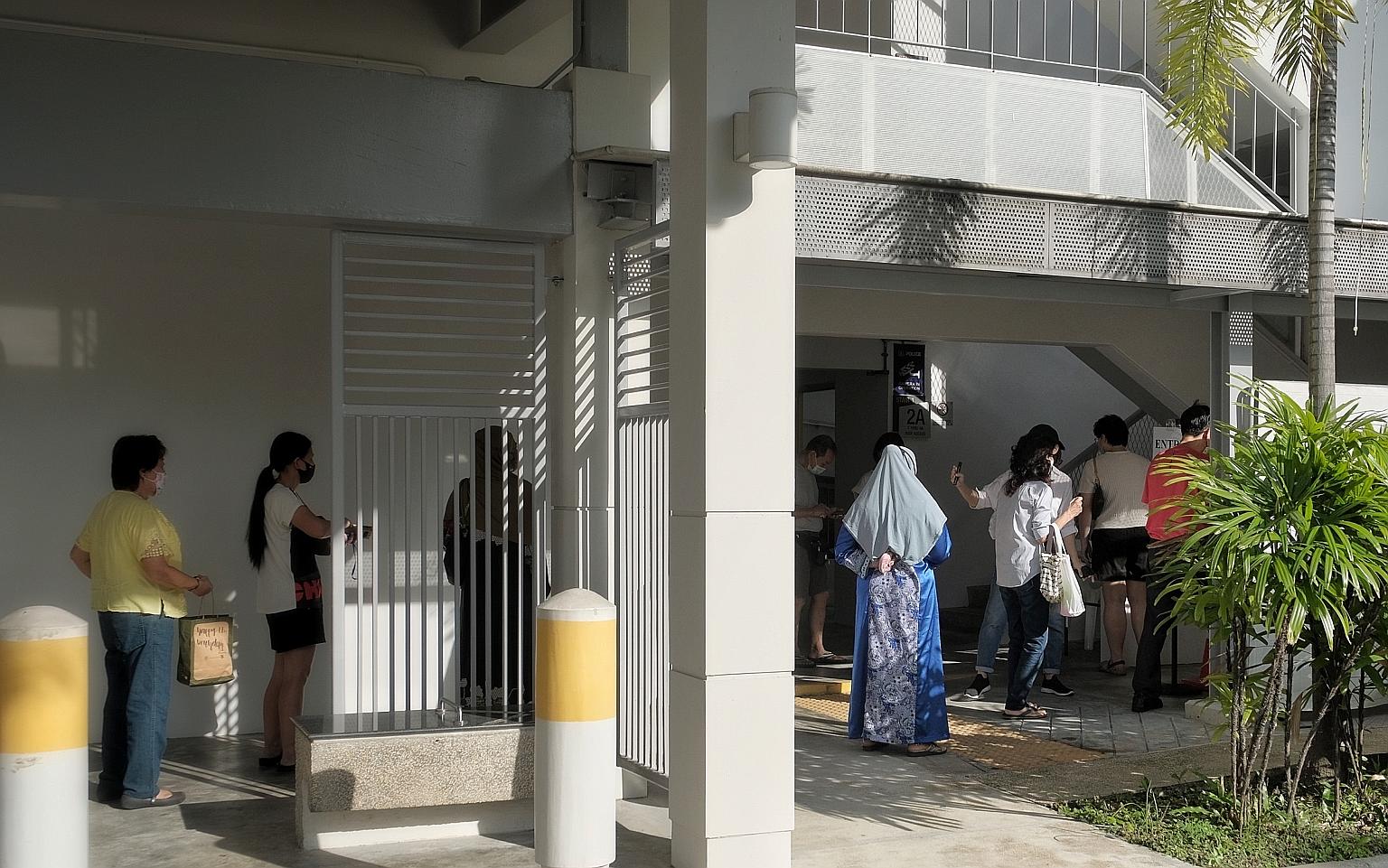 Stallholders and cleaners from Telok Blangah Drive Food Centre and Market queueing yesterday for Covid-19 testing at Block 80D Telok Blangah Street 31, after a second food centre worker was confirmed to be infected.