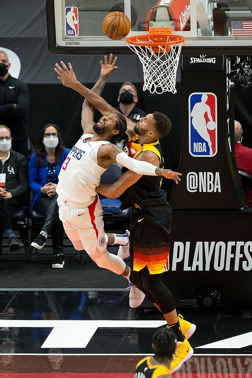 Clippers guard Paul George getting in a shot despite being marked by Jazz centre Rudy Gobert in Game 5 of their NBA Western Conference semi-final series on Wednesday. The Clippers won to lead 3-2 after trailing 2-0.
