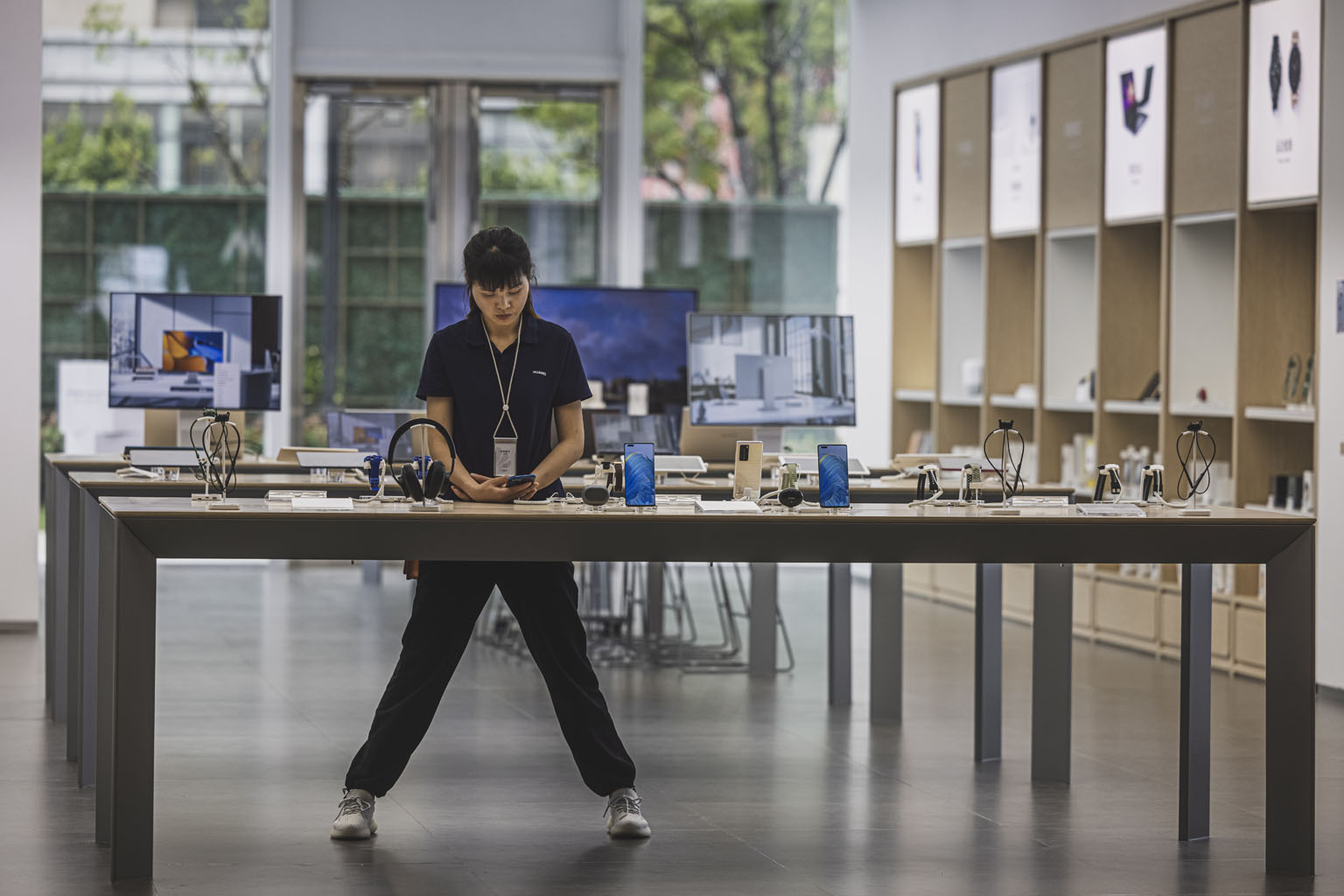 An employee at a Huawei store in Shanghai. Hangzhou Hikvision Digital Technology and Dahua Technology, whose cameras can be found in US schools and local government facilities, telecom giant ZTE, two-way radio maker Hytera Communications and Huawei T