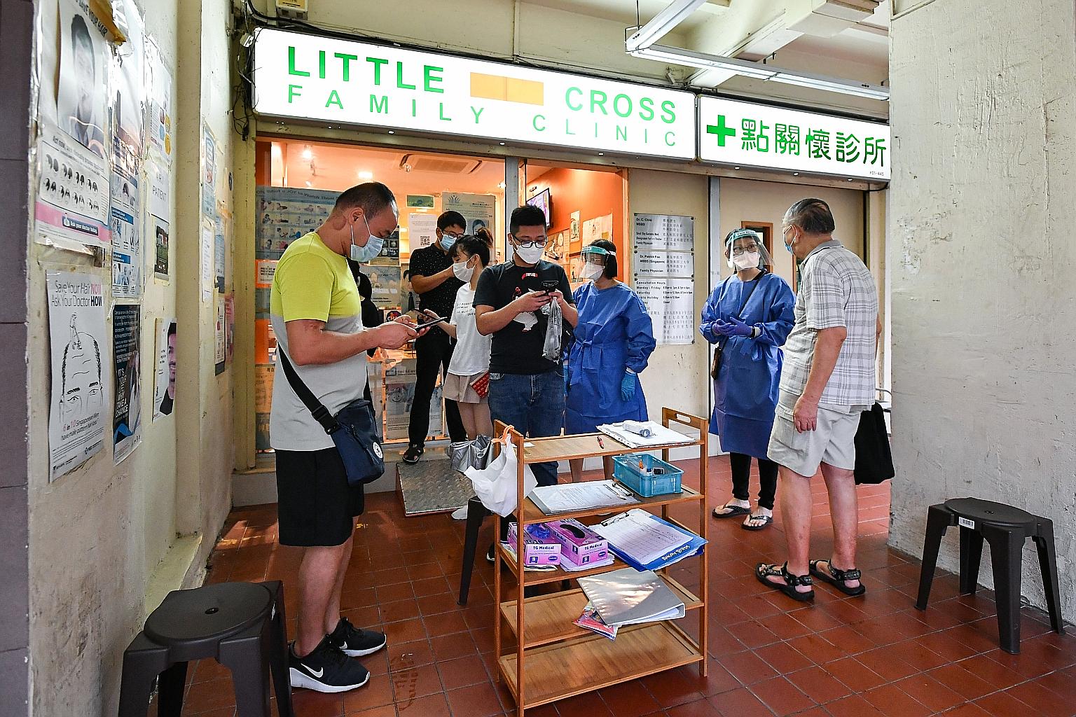 People inquiring about the Sinovac vaccine at Little Cross Family Clinic in Tampines Street 91 yesterday. The clinic had to tell people waiting outside to leave their details as it had yet to receive the doses.ST PHOTO: LIM YAOHUI
