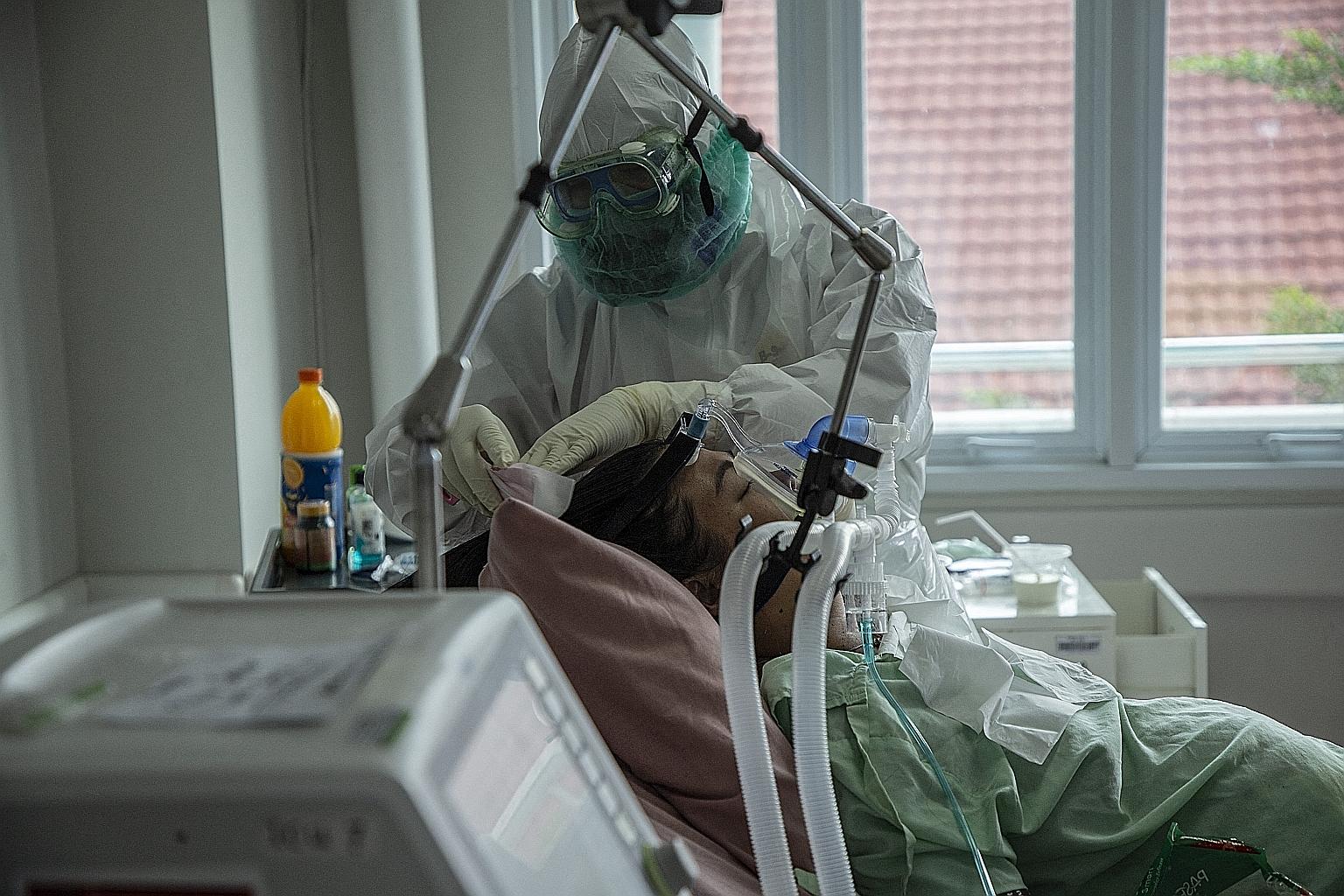 A Covid-19 patient in an Indonesian hospital's intensive care unit yesterday. There are growing calls for a lockdown to curb the spread of the virus as hospital bed occupancy in Jakarta shot up to 75 per cent, from 45 per cent last week. PHOTO: AGENC