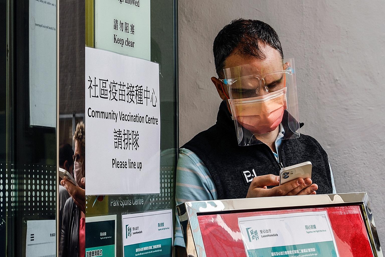 A man waiting in line at a vaccination centre in Hong Kong in March. A study by the University of Hong Kong found that some people who received the Sinovac vaccine might need a third booster shot.