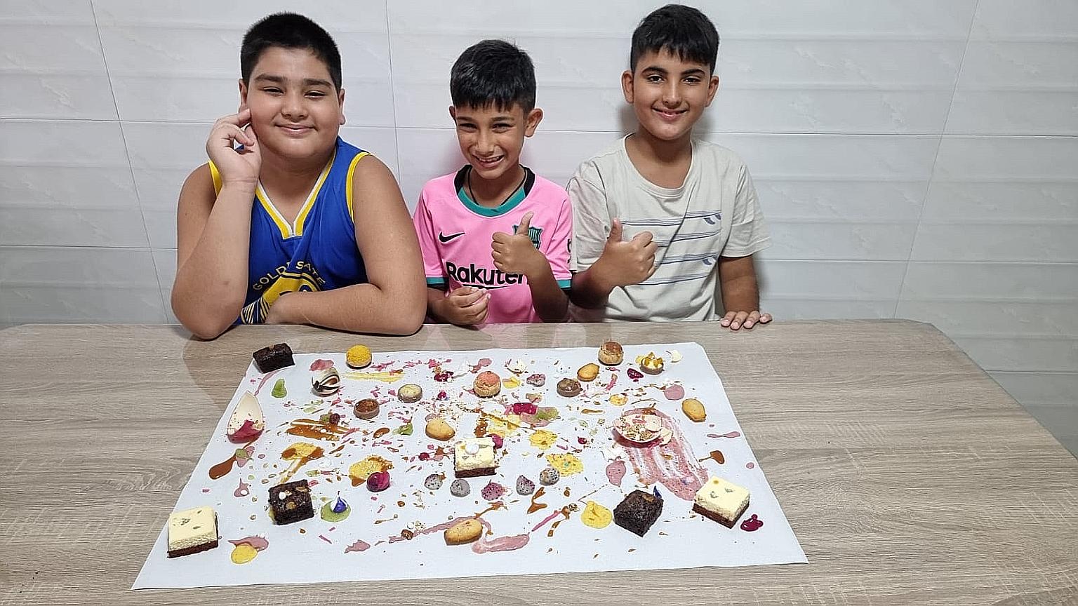 (From far left) Brothers Keagen, 10, Harjas, eight, and Jagveer Singh, nine, with their completed dessert painting.