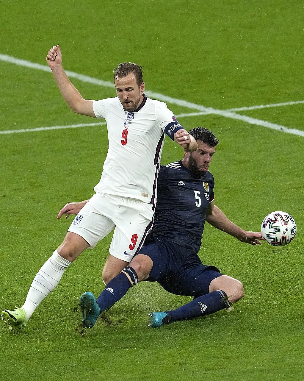 England captain and striker Harry Kane (tackled by Scotland's Grant Hanley) has looked lethargic, sluggish and off the pace in Euro 2020.