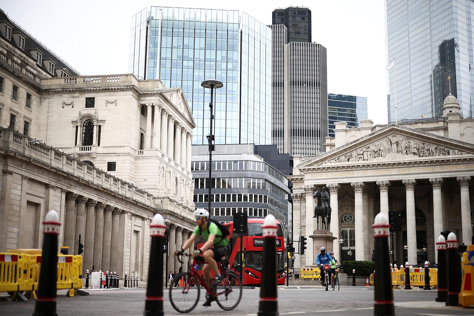 Cyclists passing the Bank of England in London. The City of London's decades-long role as the hub of European finance has been dented somewhat since Britain voted to leave the European Union. PHOTO: REUTERS