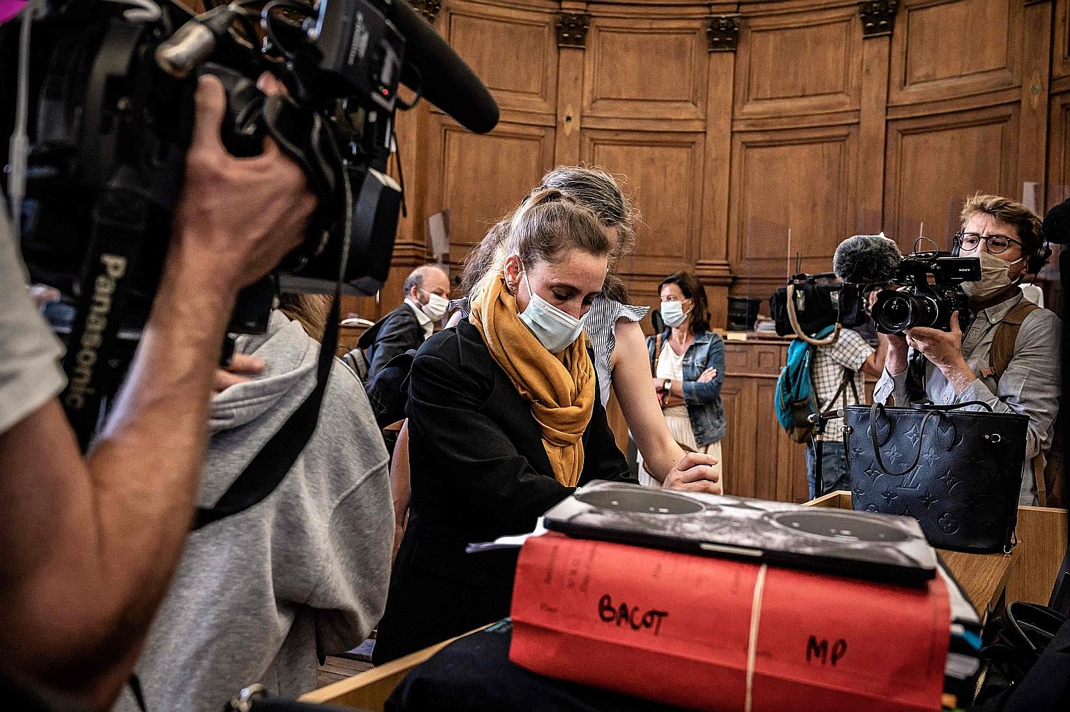 Valerie Bacot (with yellow scarf) arriving at the Chalon-sur-Saone courthouse, prior to the opening hearing of her murder trial on Monday. Her story of violent abuse by her rapist stepfather, who later became her husband and pimp, has moved campaigne